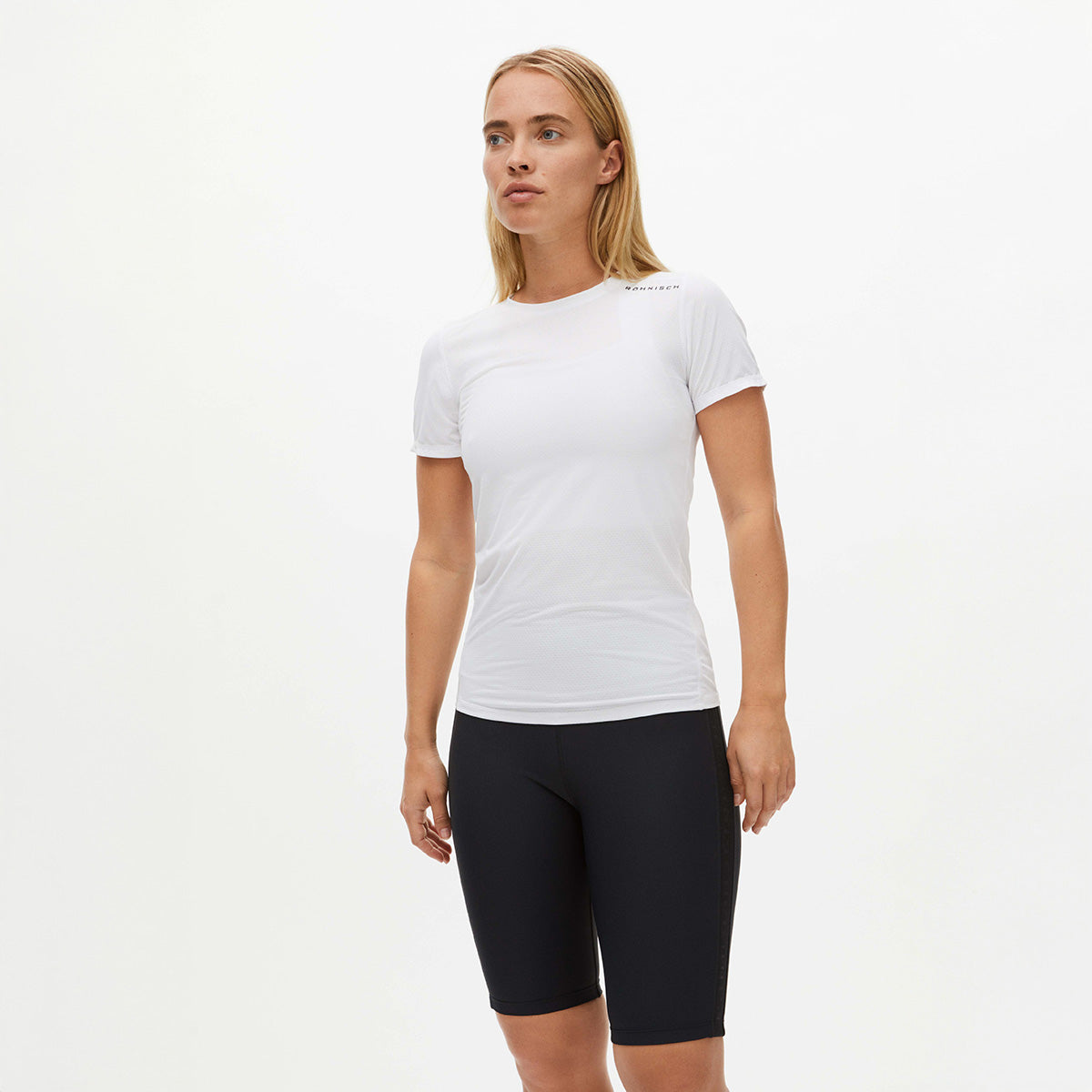 A person in a breathable Rohnisch Jacquard Short Sleeve Tee and recycled polyester black shorts stands against a plain white background.