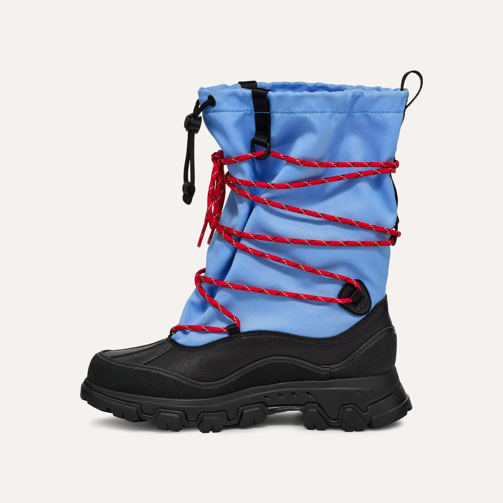 The W Metropeak by Ugg, a blue winter boot with red laces and drawstring closure, features a waterproof design with a black sole and rugged tread, ideal for any adventure against the elements.