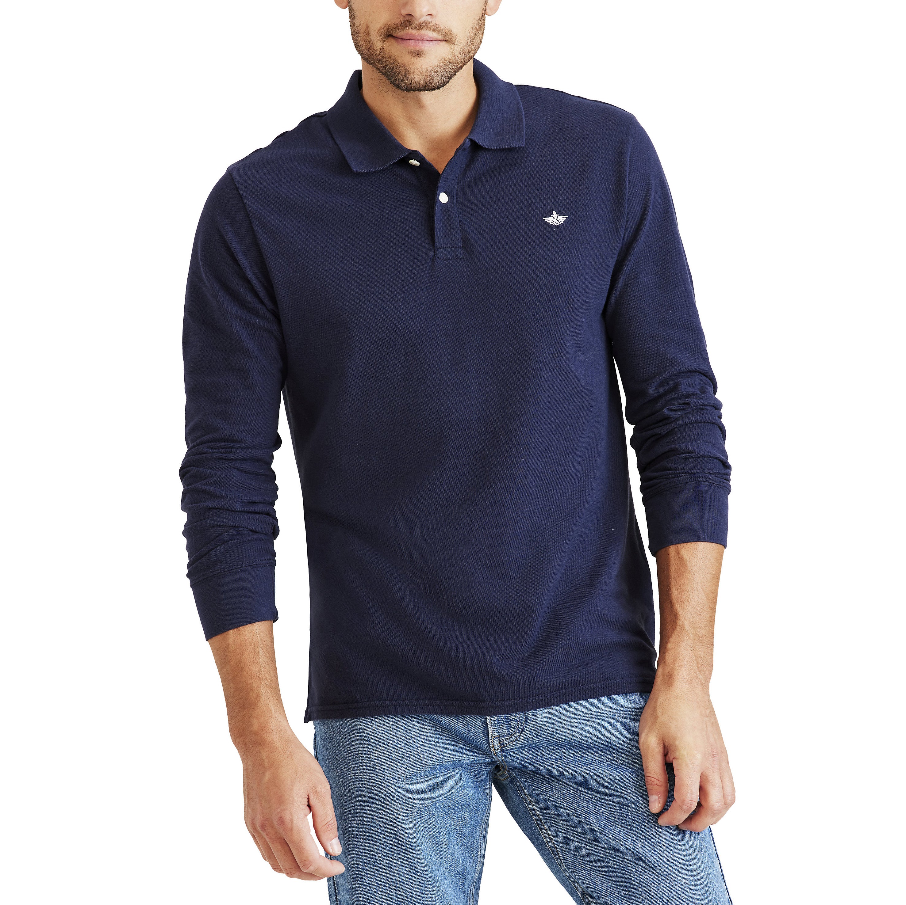 A man stands against a plain white background wearing Dockers Men's Pique Polo, LS in slim fit navy blue with a no roll collar, paired with light blue jeans.