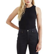 A person stands against a plain backdrop, wearing a sleek Dockers Women's Rib Tank with Loft Knit and matching black jeans.