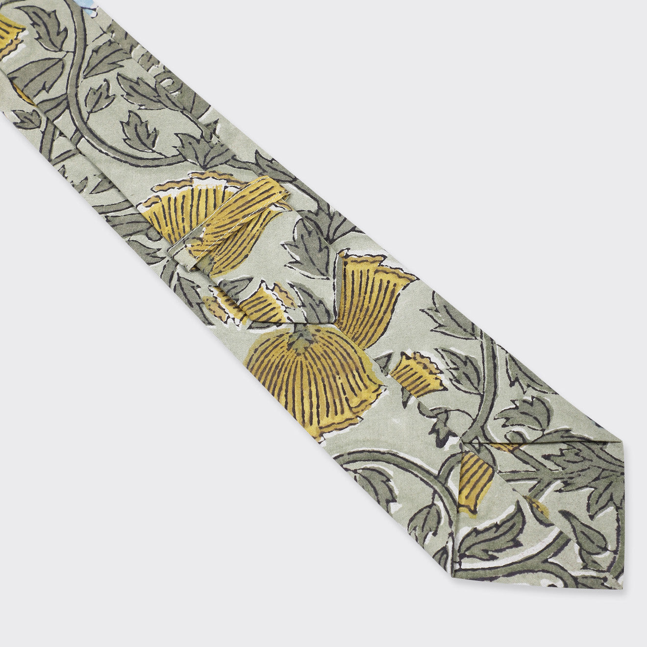 The Kardo Tie, Block Print 137 features a floral pattern with yellow flowers and green leaves on a light gray background.