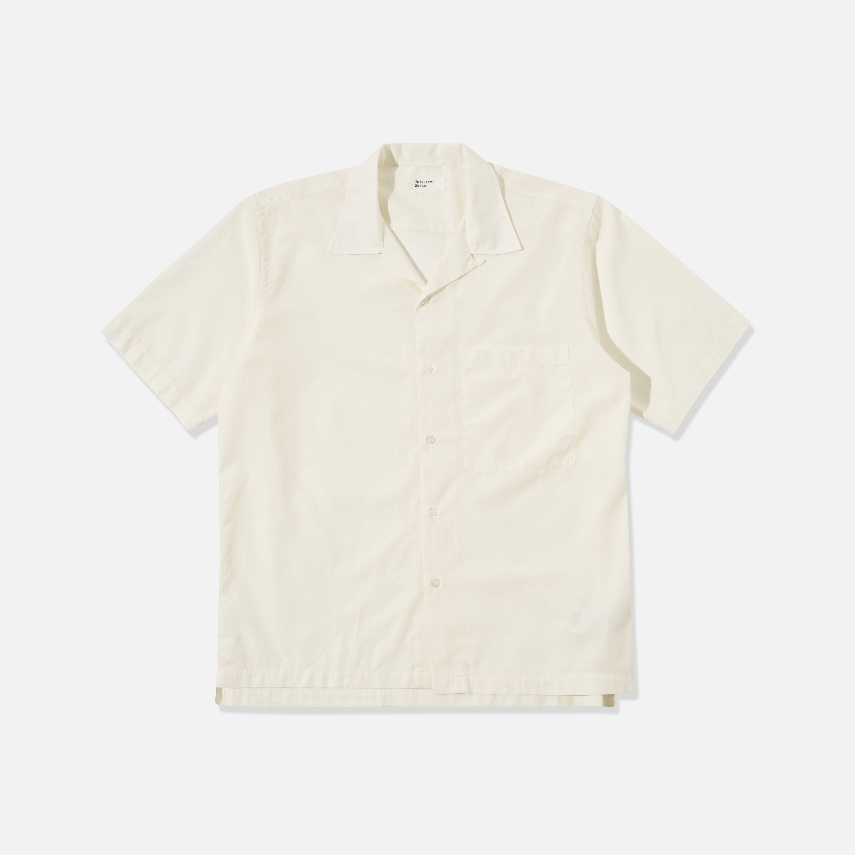 The Universal Works Gardenia Lycot Camp Shirt in ecru is a short-sleeved, button-up shirt with a chest pocket, shown laid flat on a plain white background.