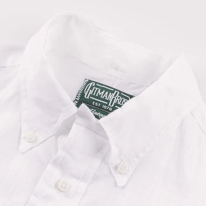 Close-up of a white linen shirt with a visible Gitman Vintage label on the inside collar.