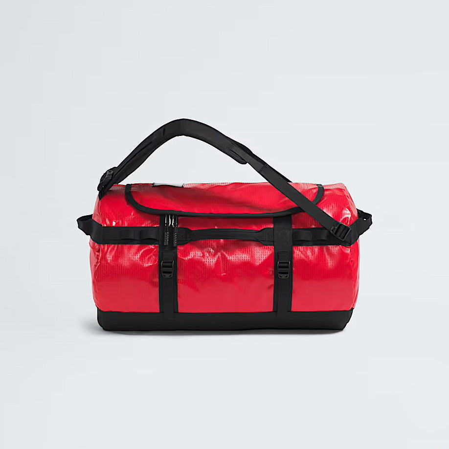 The North Face Base Camp Duffel in TNF Red, featuring black straps and handles, sits on a plain white background—perfect for any adventure.