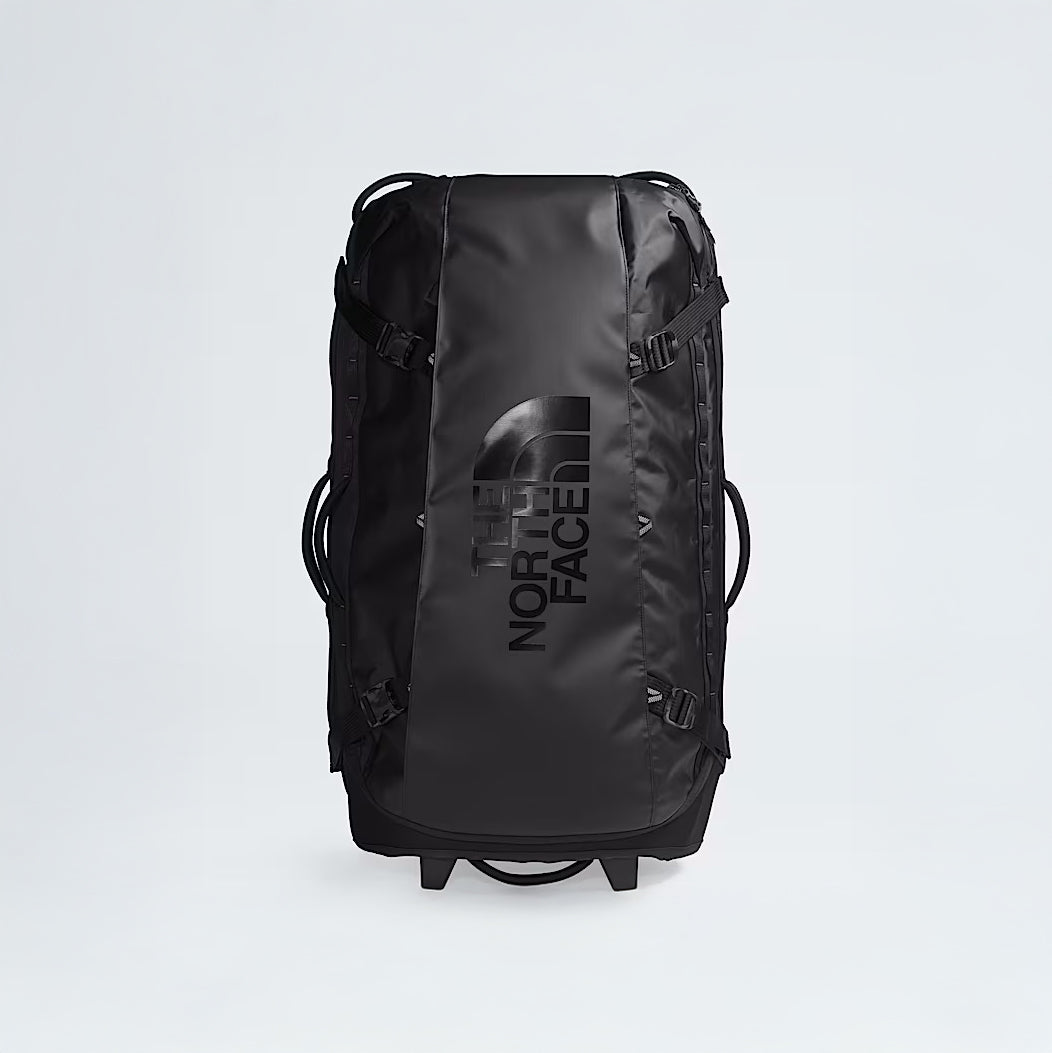 The North Face Base Camp Rolling Thunder 36 Luggage, a large black duffel made with recycled fabric and a hard-shell chassis, is shown standing upright on a plain white background.