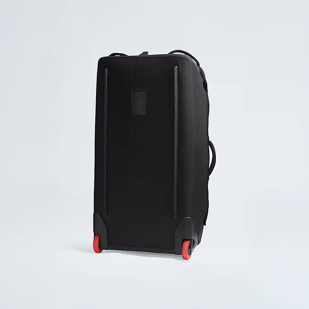 The North Face Base Camp Rolling Thunder 36 Luggage, a large black rolling suitcase with red wheels, is shown against a plain light background.