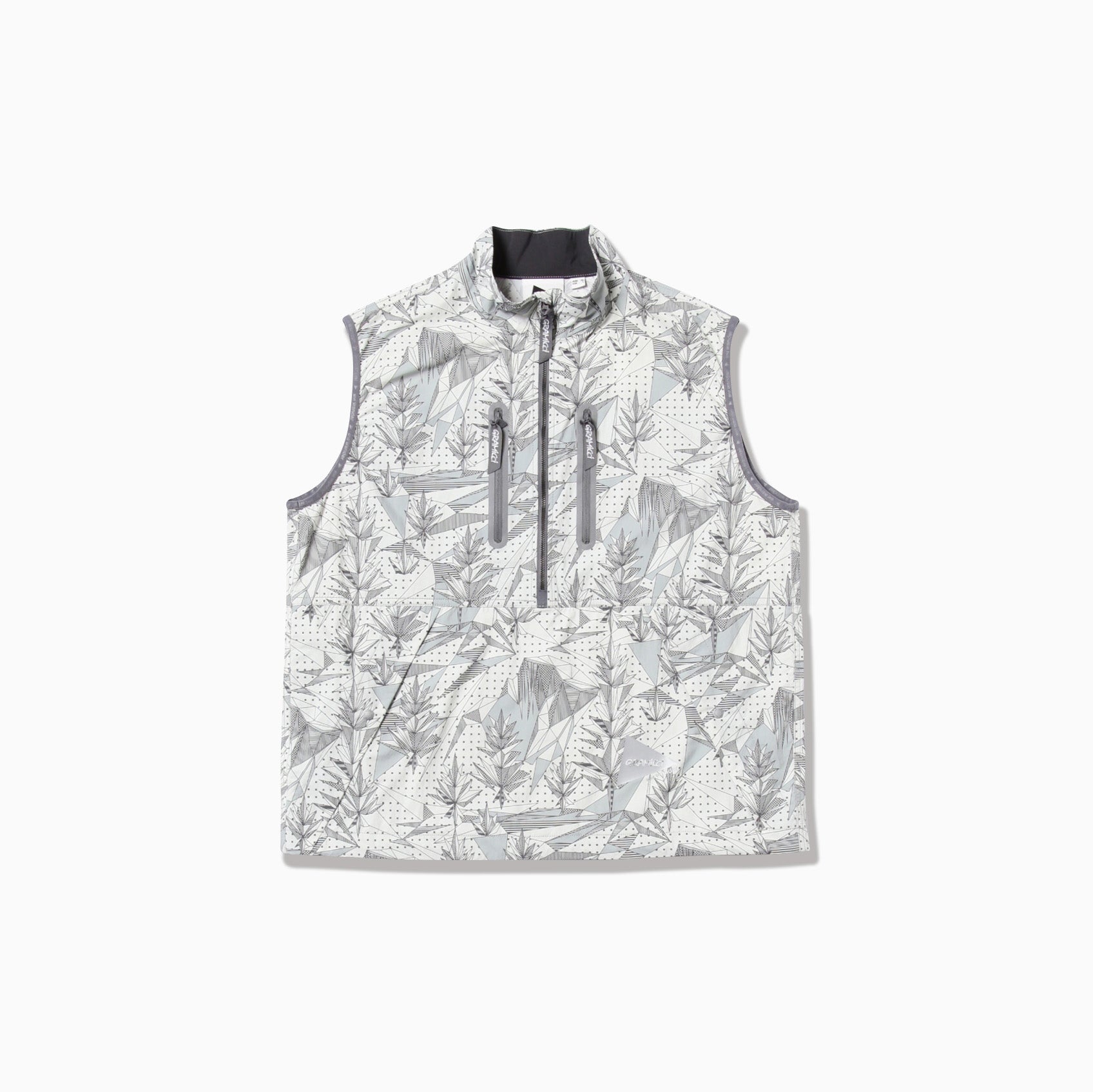 The Brushed Nylon Vest by Gramicci x And Wander features a sleeveless design with a white and gray leaf pattern, stand-up collar, and multiple front zippers, set against a plain white background.