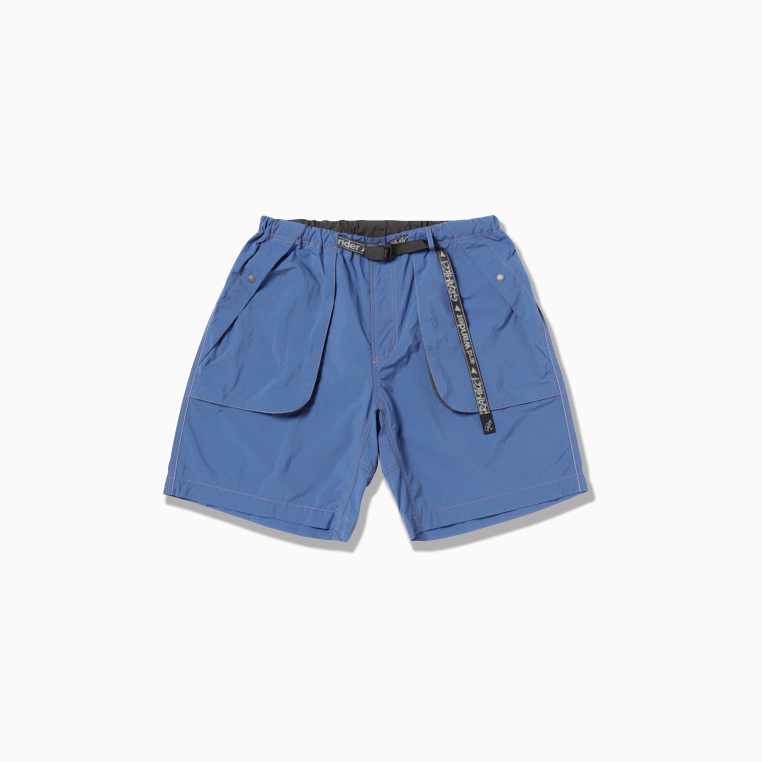 The Gramicci x And Wander Brushed Nylon Short features large front pockets, an adjustable black belt, and is crafted from lightweight fabric ideal for casual wear.