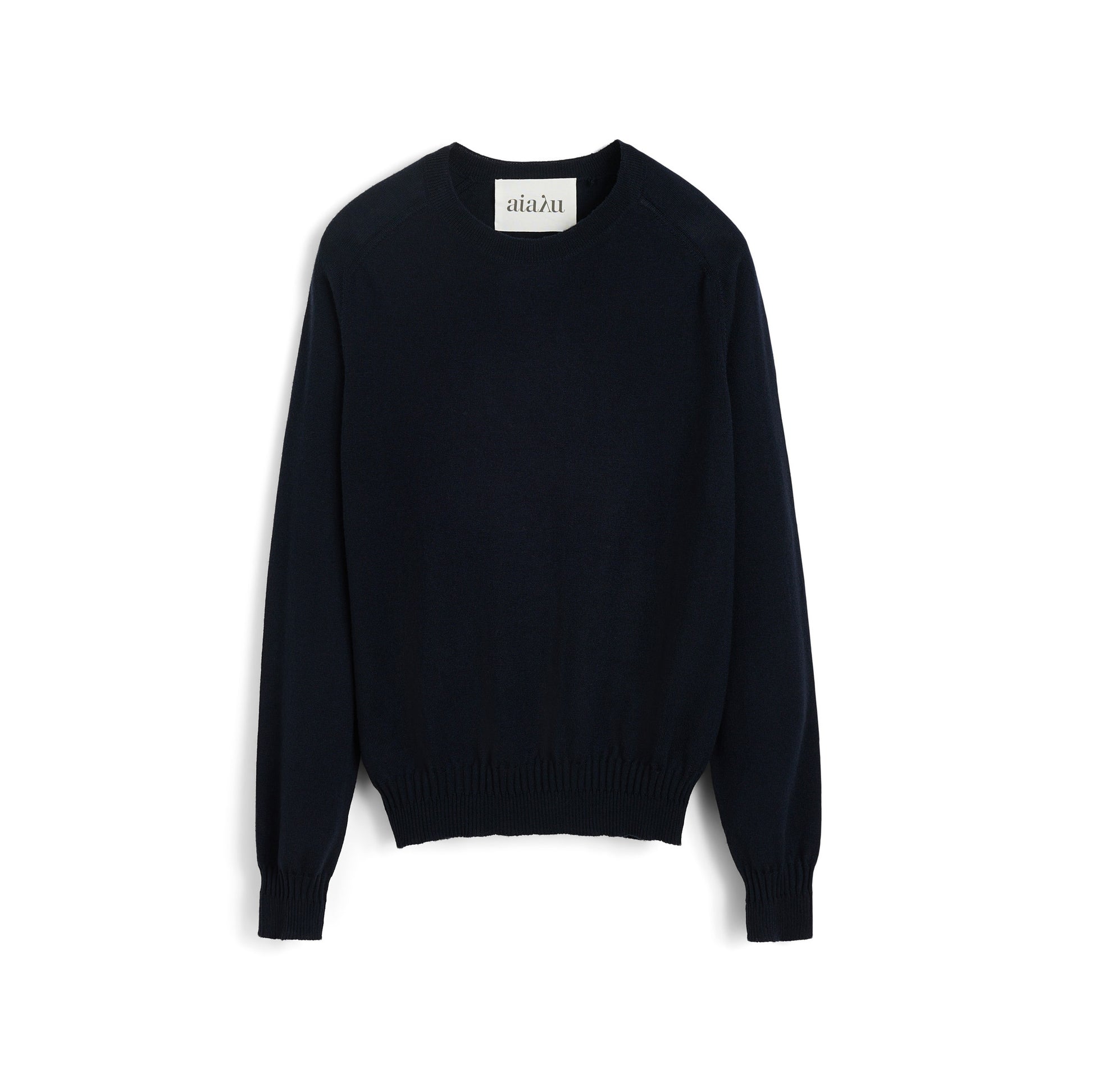 The Aiayu Gina Sweater is a black crewneck made from 100% merino wool, featuring long sleeves and ribbed cuffs, displayed against a white background.