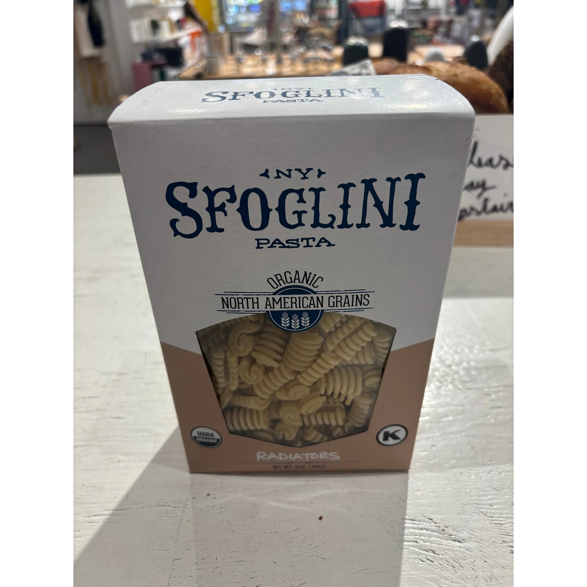 A box of Westerlind organic radiatori pasta made from north american grains, placed on a store shelf.