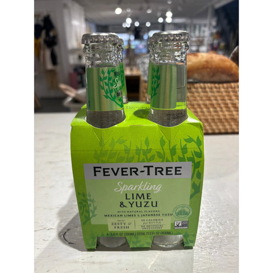 Two bottles of Westerlind Sparkling Lime & Yuzu beverage on a store shelf, in vibrant green packaging.