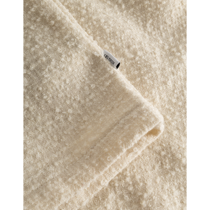 Close-up of a beige Kevin Boucle Shirt, Ivory fabric with a visible Les Deux label sewn into the seam.