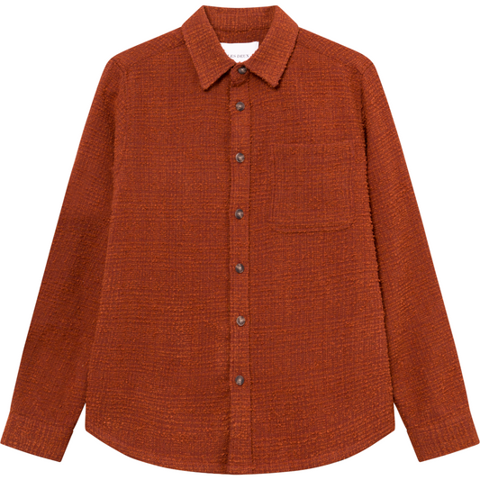 A Court Orange Kevin Boucle Shirt by Les Deux, featuring a collar and two chest pockets, crafted from recycled fibers, displayed on a plain background.