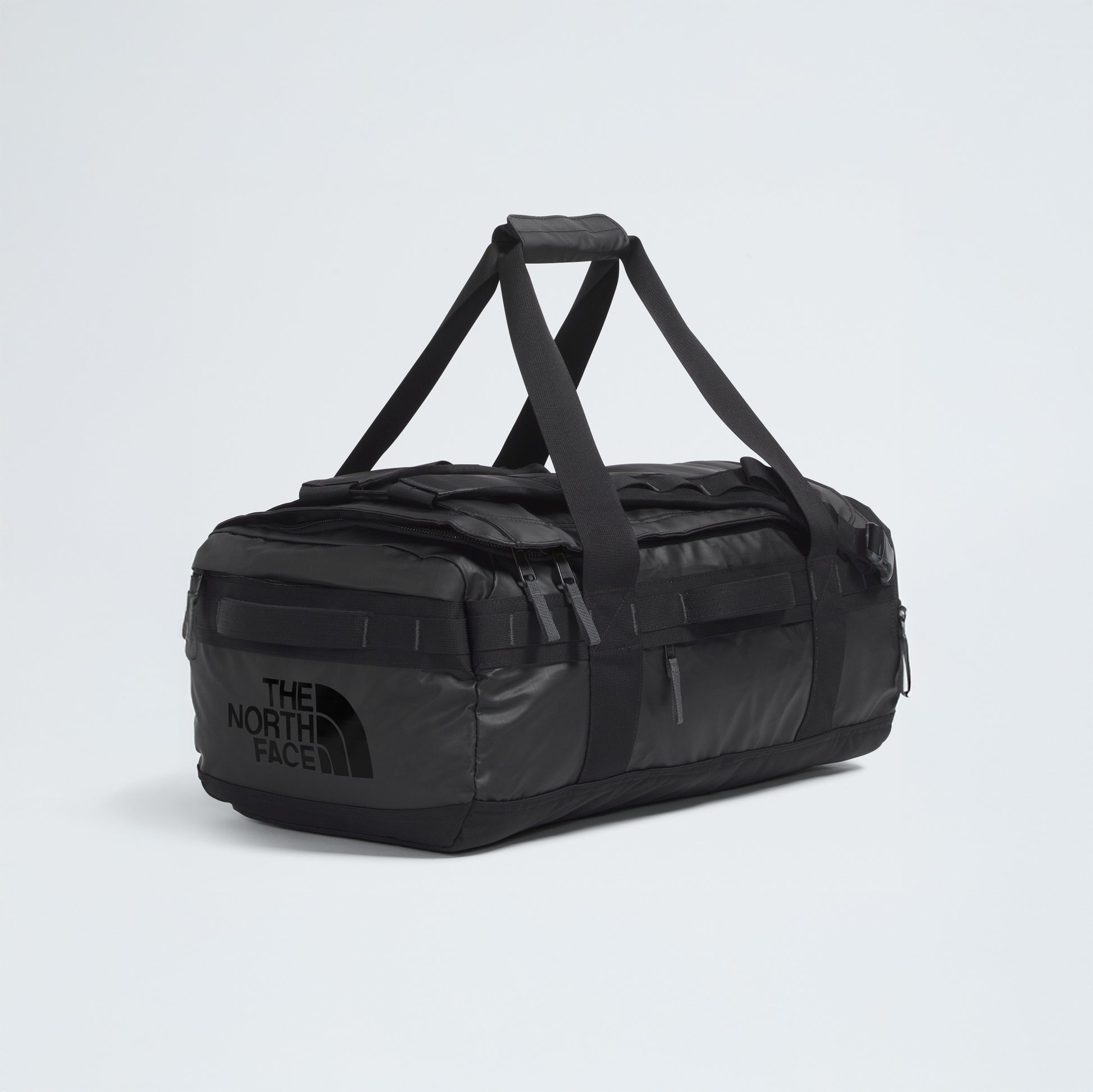 The North Face Base Camp Voyager Duffel - 42L, shown in black with multiple handles and zippers against a plain light background, highlights its lightweight design—an ideal companion for travel and adventure.
