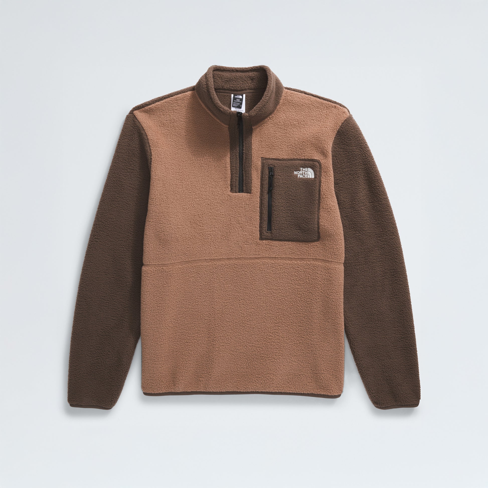 The North Face M Yumiori 1/4 Zip is a brown and dark brown pullover crafted from recycled fleece, featuring a zippered collar, chest pocket, and a logo on the left chest.
