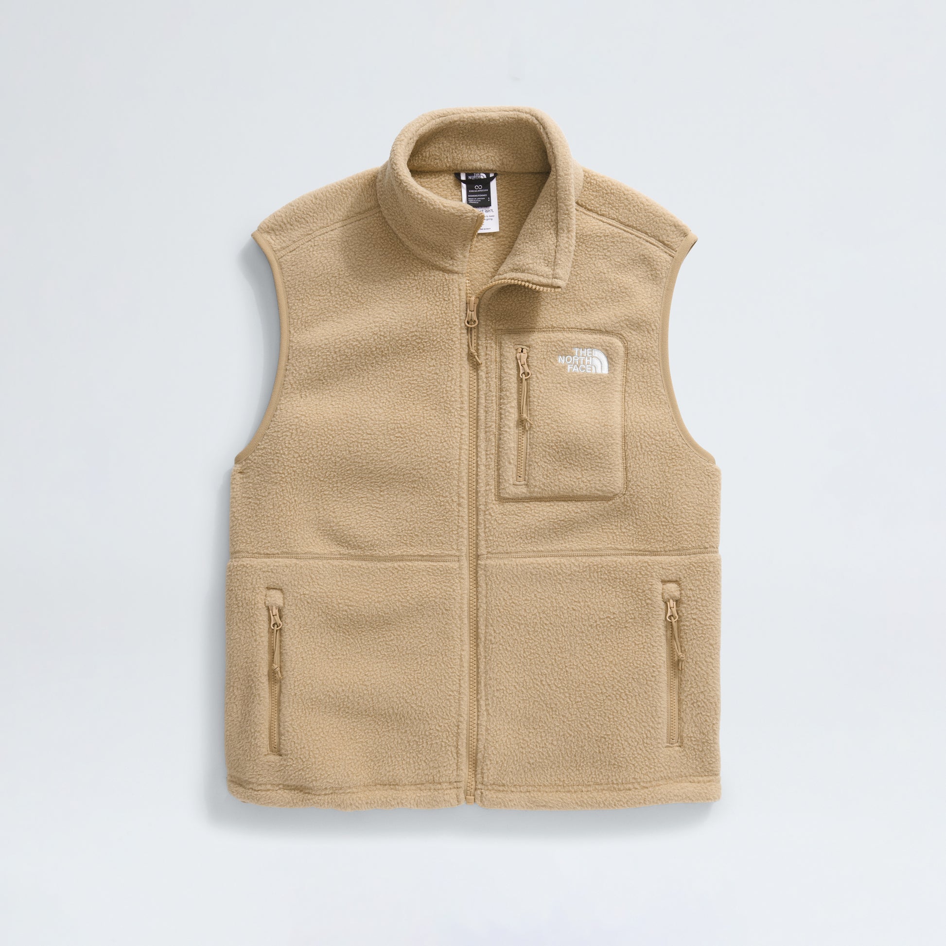 The North Face's W Yumiori Vest, made from high-pile beige fleece, includes a high collar, zipper closure, two front zip pockets, a logo chest pocket on the left side, and an adjustable hem for a tailored fit.