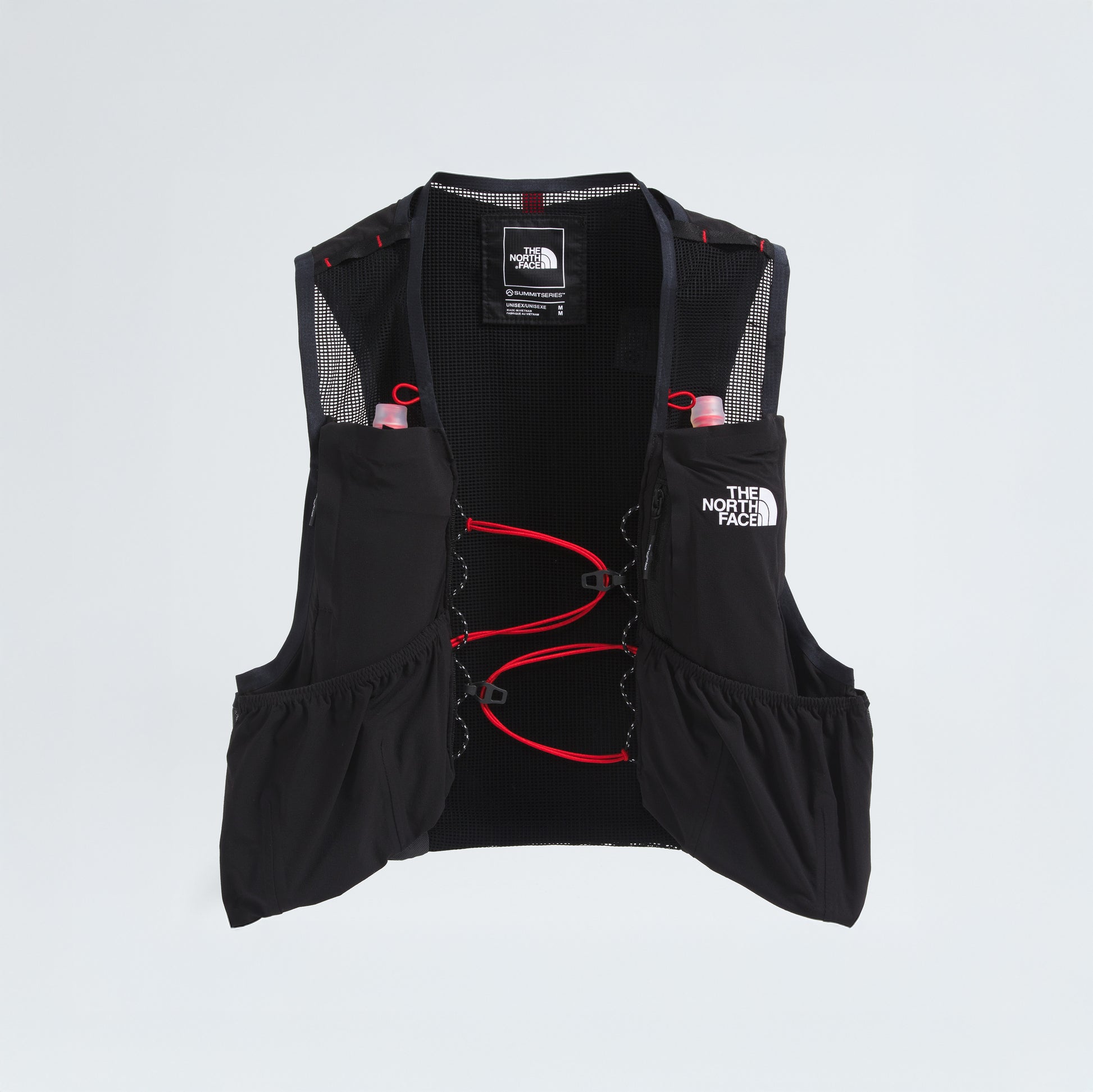 The North Face's U Summit Run Vest 5 is a black racing vest with red accents, mesh panels, multiple pockets, and two pink water bottles in front pockets against a white background—ideal for race day.