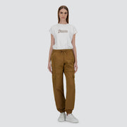 A woman faces forward against a plain light background, wearing a white Herno t-shirt, brown Herno Taffeta Cargo Zip pants, and white sneakers.