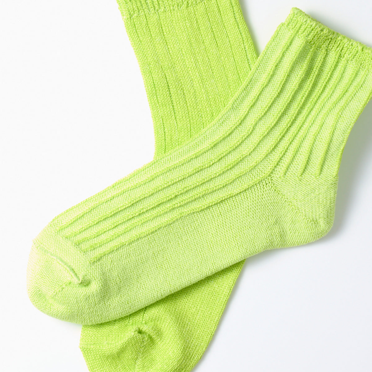 A pair of RoToTo's lime Everyday Pile Ankle Socks on a white background.