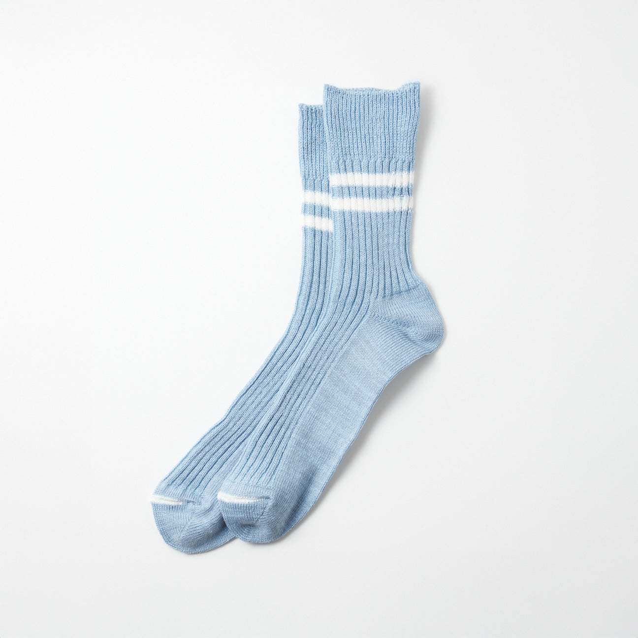 A pair of RoToTo Hemp/Organic Cotton Stripe Socks in Morning Blue with two white stripes, laid flat on a white background.
