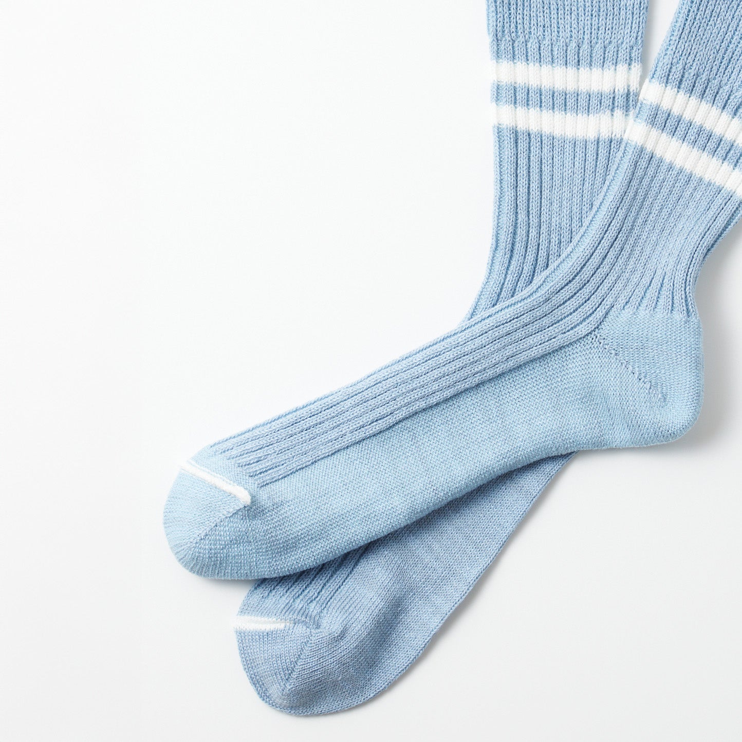 Two folded knee-high socks in morning blue with white stripes near the top and white accents on toes and heels, showcased on a white background. Product: RoToTo Hemp/Organic Cotton Stripe Sock, Morning Blue/White.