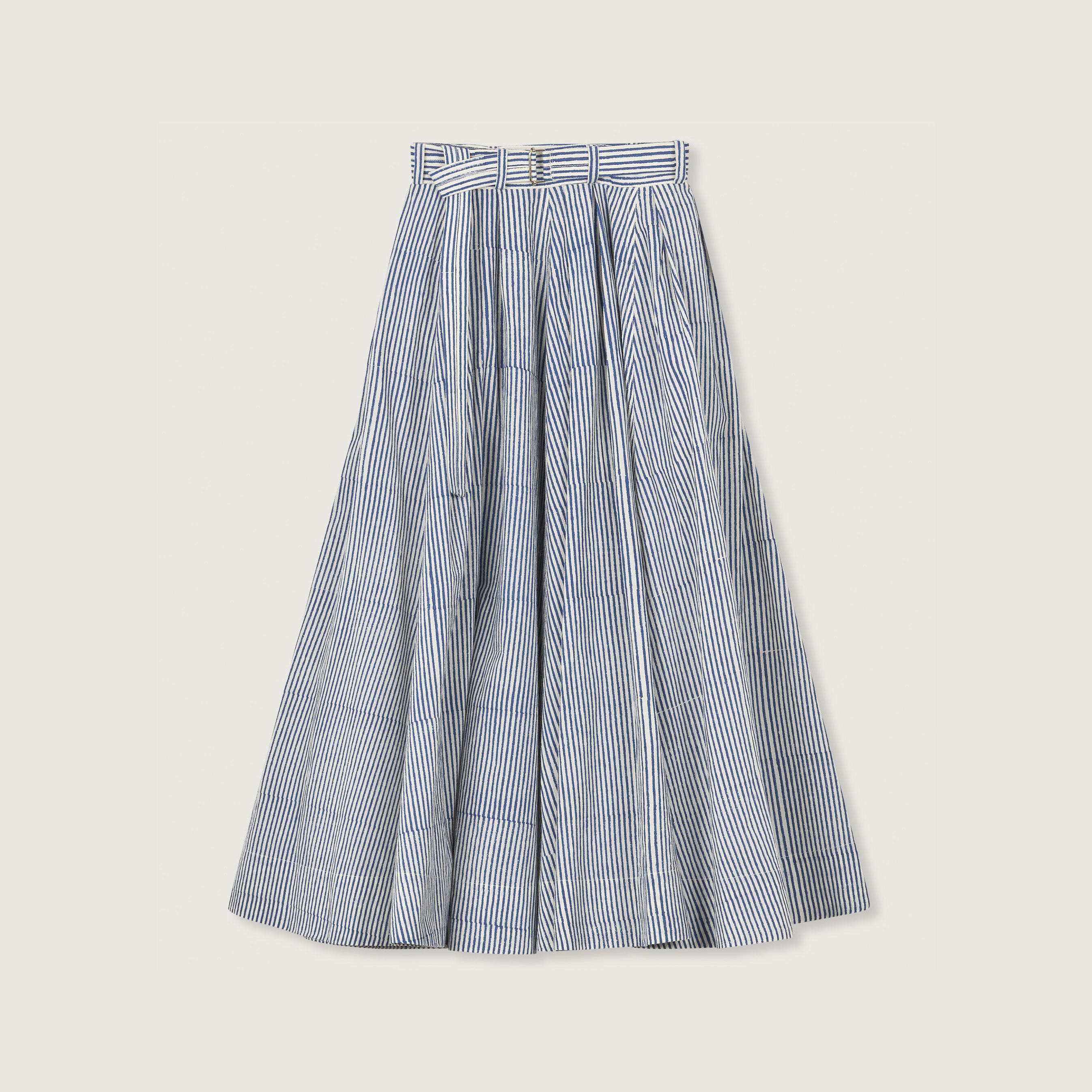 The Jan Machenhauer Schrol Skirt features a long, high-waisted silhouette in block print navy stripes with a matching belt and wide pleats, displayed on a plain background.