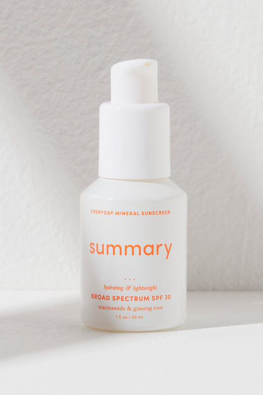 Bottle of Summary SPF 30 mineral-based sunscreen by Free People Movement on a light textured background.