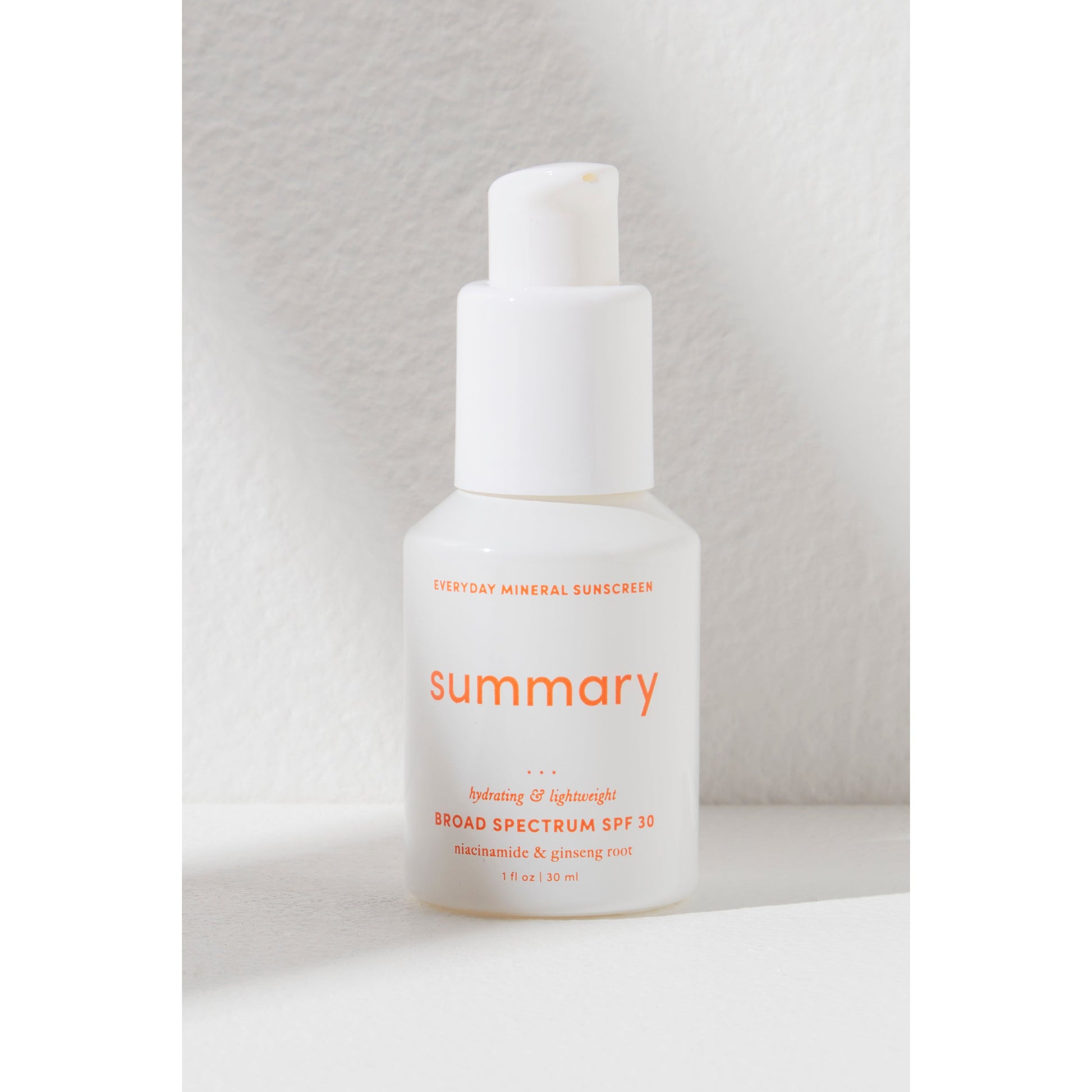 Bottle of Summary SPF 30 mineral-based sunscreen by Free People Movement on a light textured background.