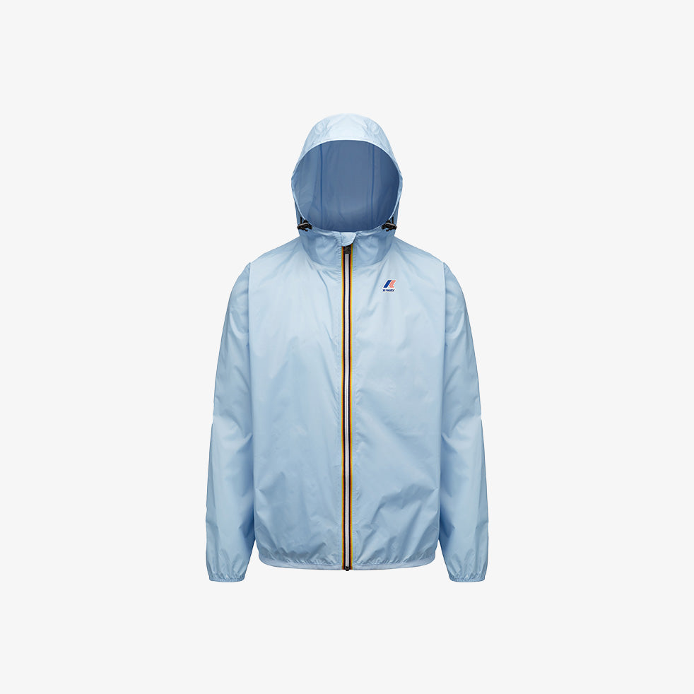 The K-Way Le Vrai 3.0 Claude jacket in Azure LT Marine is a light blue unisex short jacket with a front zipper and elastic cuffs, made from windproof ripstop fabric. This packable waterproof jacket is shown on a plain white background.