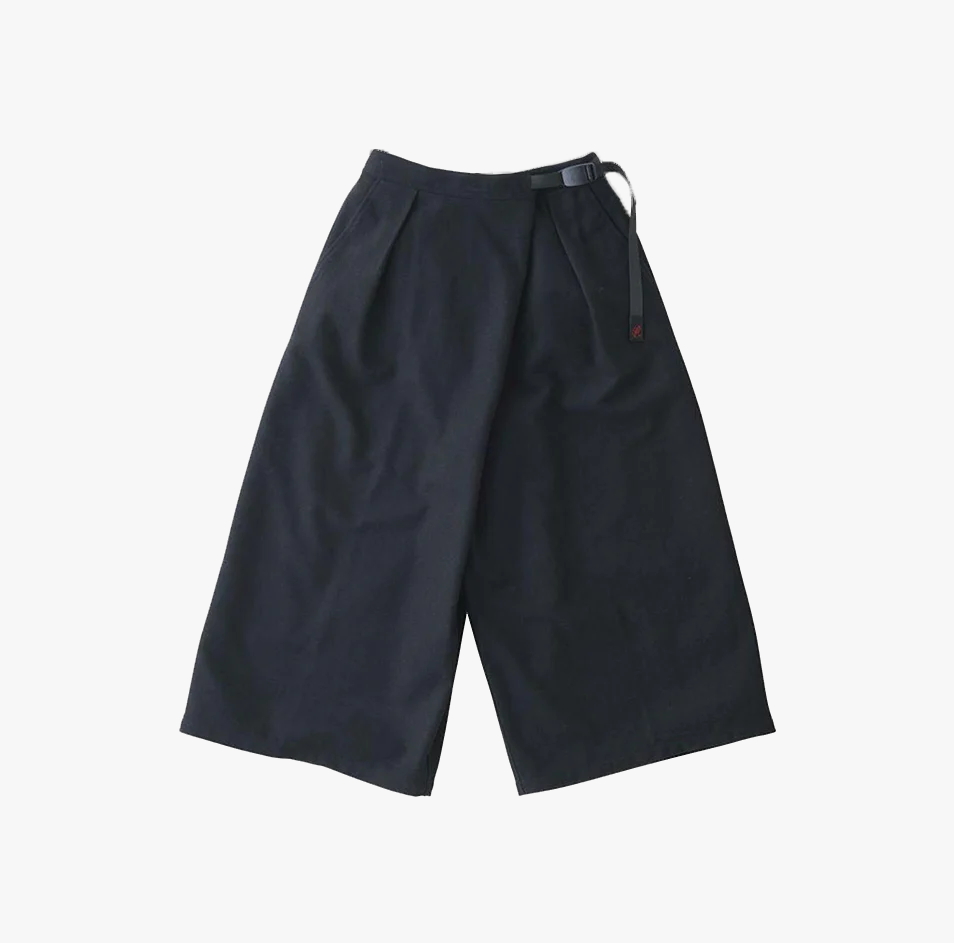 Gramicci Wool Wrap Flare Pants in navy, featuring a wide-leg silhouette and adjustable belt detail, displayed flat on a white background.