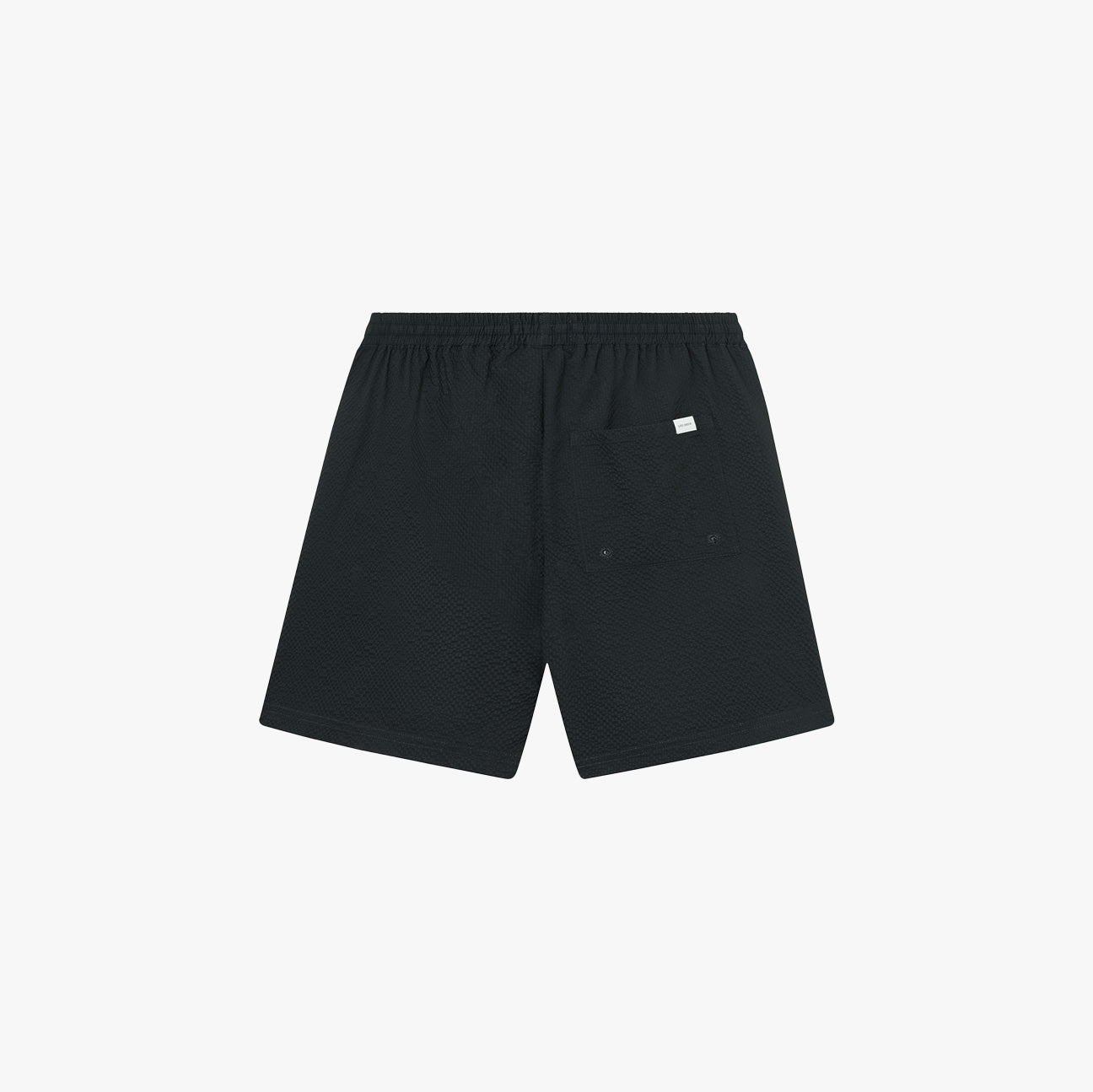 Les Deux Stan Seersucker Swim Shorts 2.0 in Dark Navy, featuring an elastic waistband and single back pocket, crafted from quick-dry seersucker. Shown flat on a white background—a versatile men’s swimwear choice for pool or beach days.