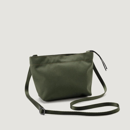 Olive green Zipper Pouch Mini crossbody bag by Bags in Progress, with a sleek design and adjustable strap, isolated on a white background.