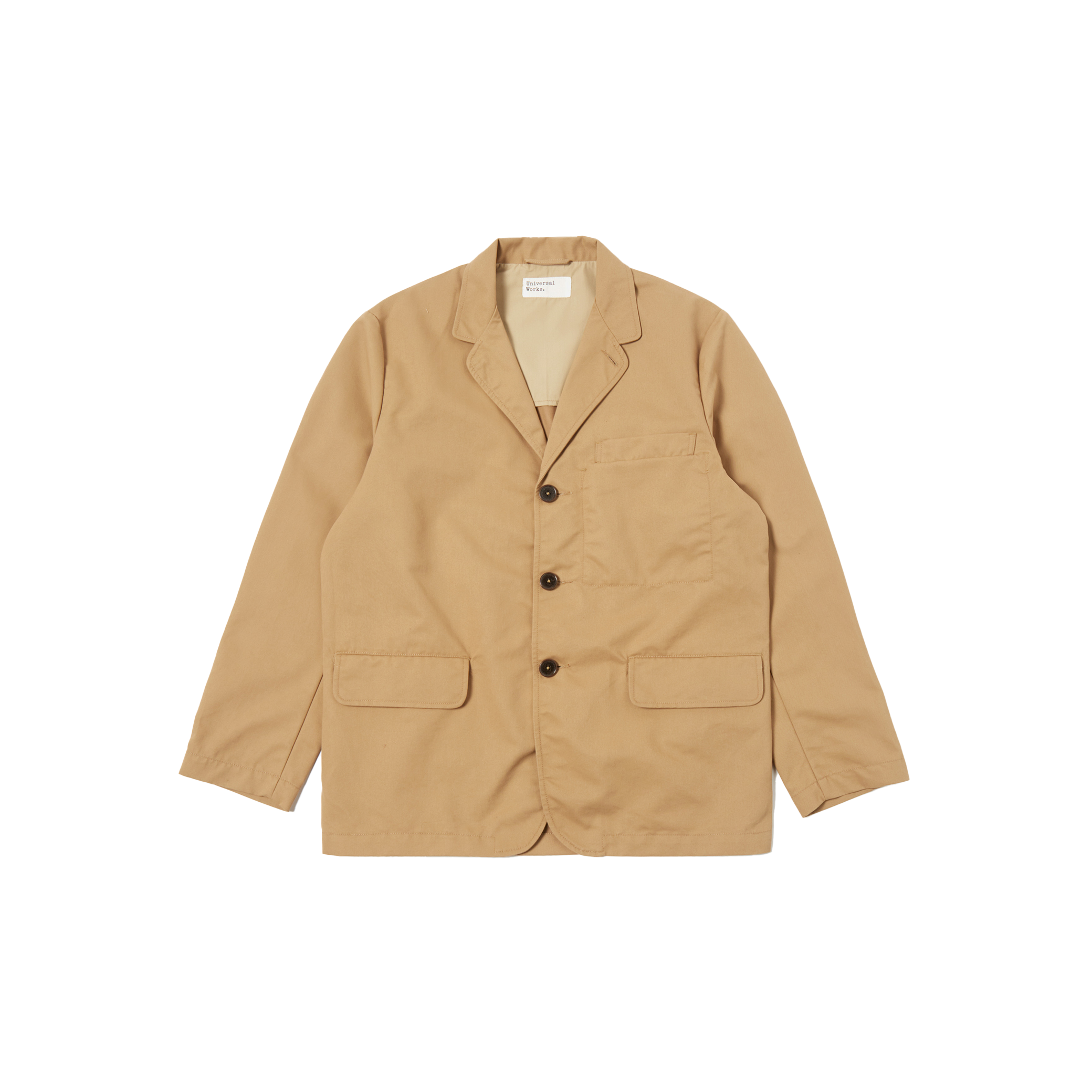 The Capitol Jacket by Universal Works is a tan blazer featuring a notched lapel, three black buttons, and two front pockets, made from recycled polyester. Displayed against a white background.