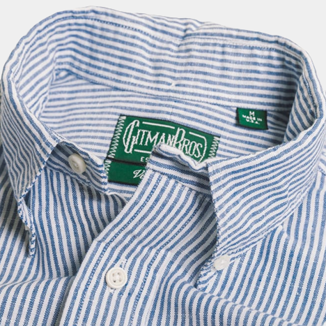 A blue and white striped button-down with a visible collar and tags displaying the Gitman Vintage brand, size medium—Blue Stripe Linen Shirt.