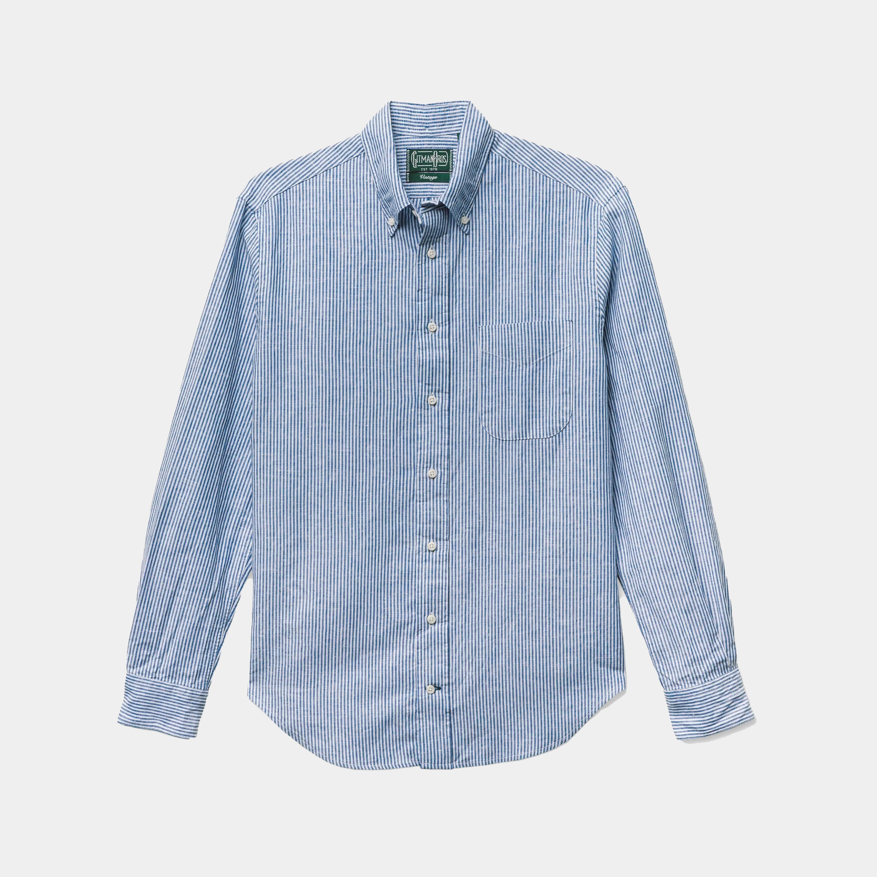 The Gitman Vintage Blue Stripe Linen Shirt features blue and white vertical stripes and is shown laid flat on a white background.