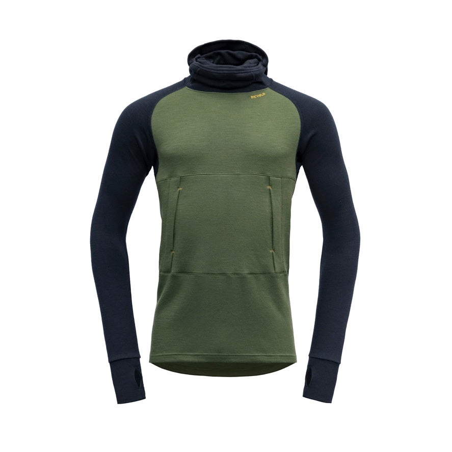 The Devold M Expedition Arctic Hoodie in Forest Ink features a green body with dark sleeves. This Merino wool hoodie from the Expedition Series includes a high collar, kangaroo pocket, and thumb holes for added comfort.