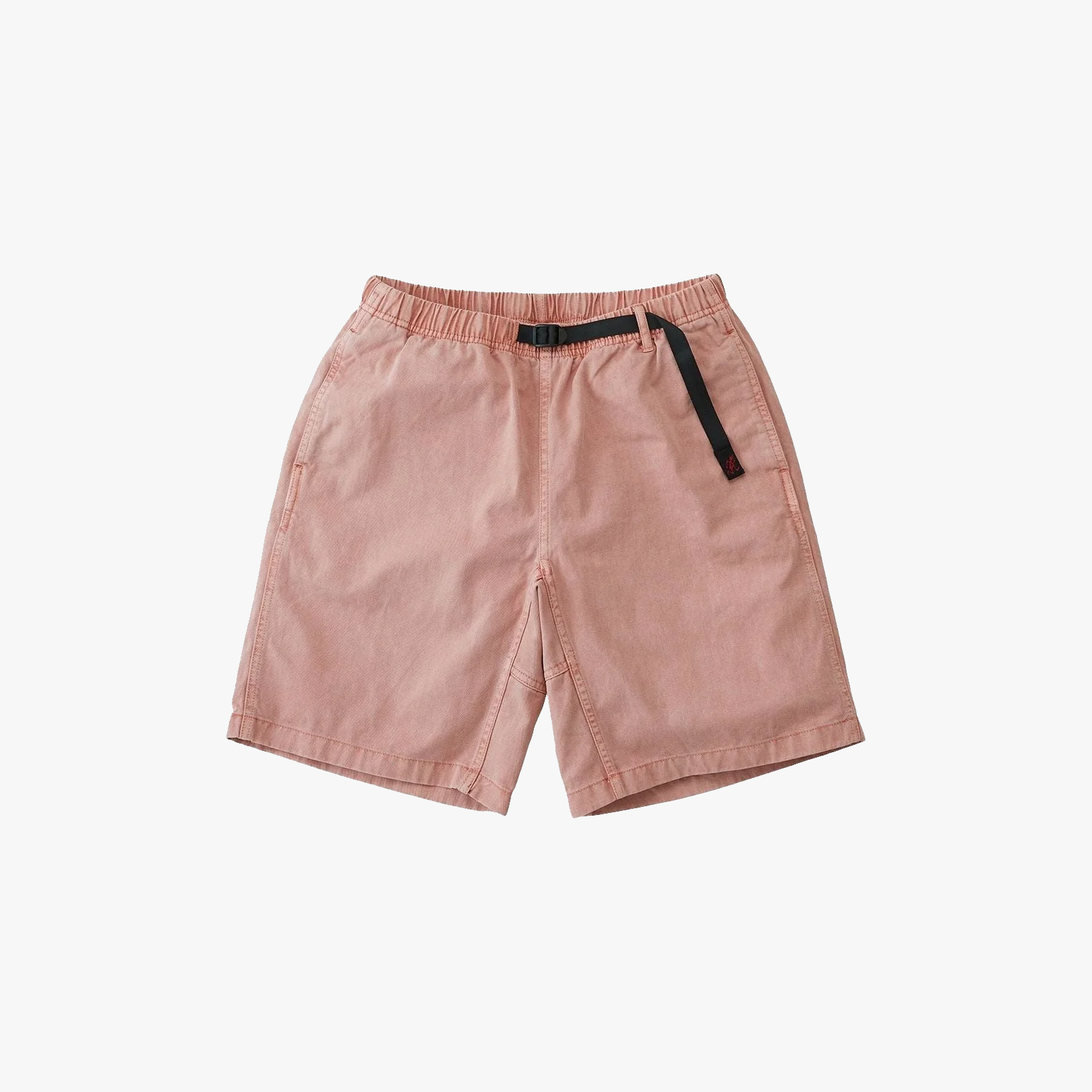 The Gramicci G-Short Pigment Dye features light pink fabric, an elastic waistband with an adjustable black buckle strap, pigment dye finish, and side pockets, displayed flat on a white background.