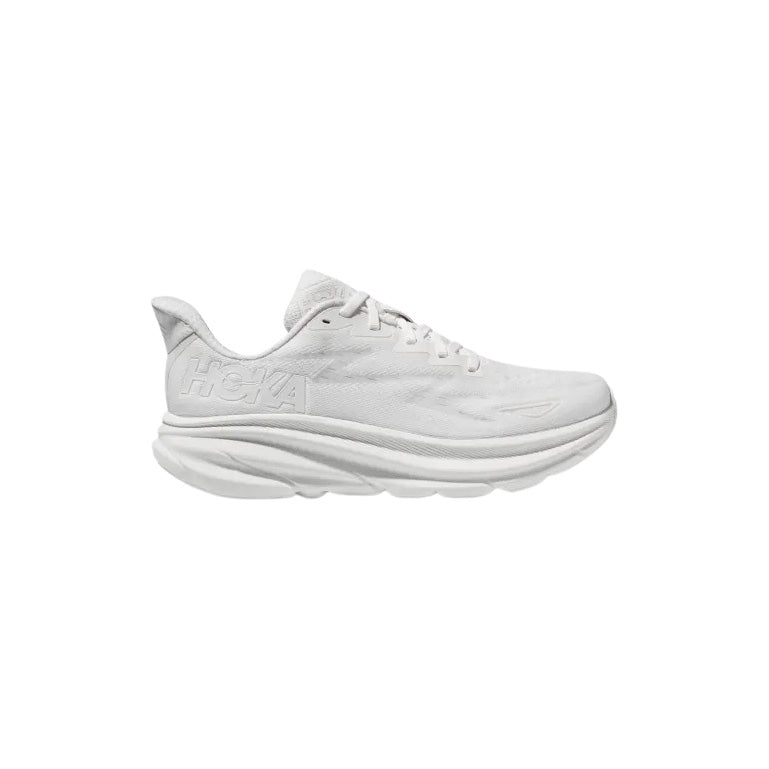 The Hoka M Clifton 9 running shoe in White/White is shown from the side, highlighting its thick cushioned sole against a plain background.