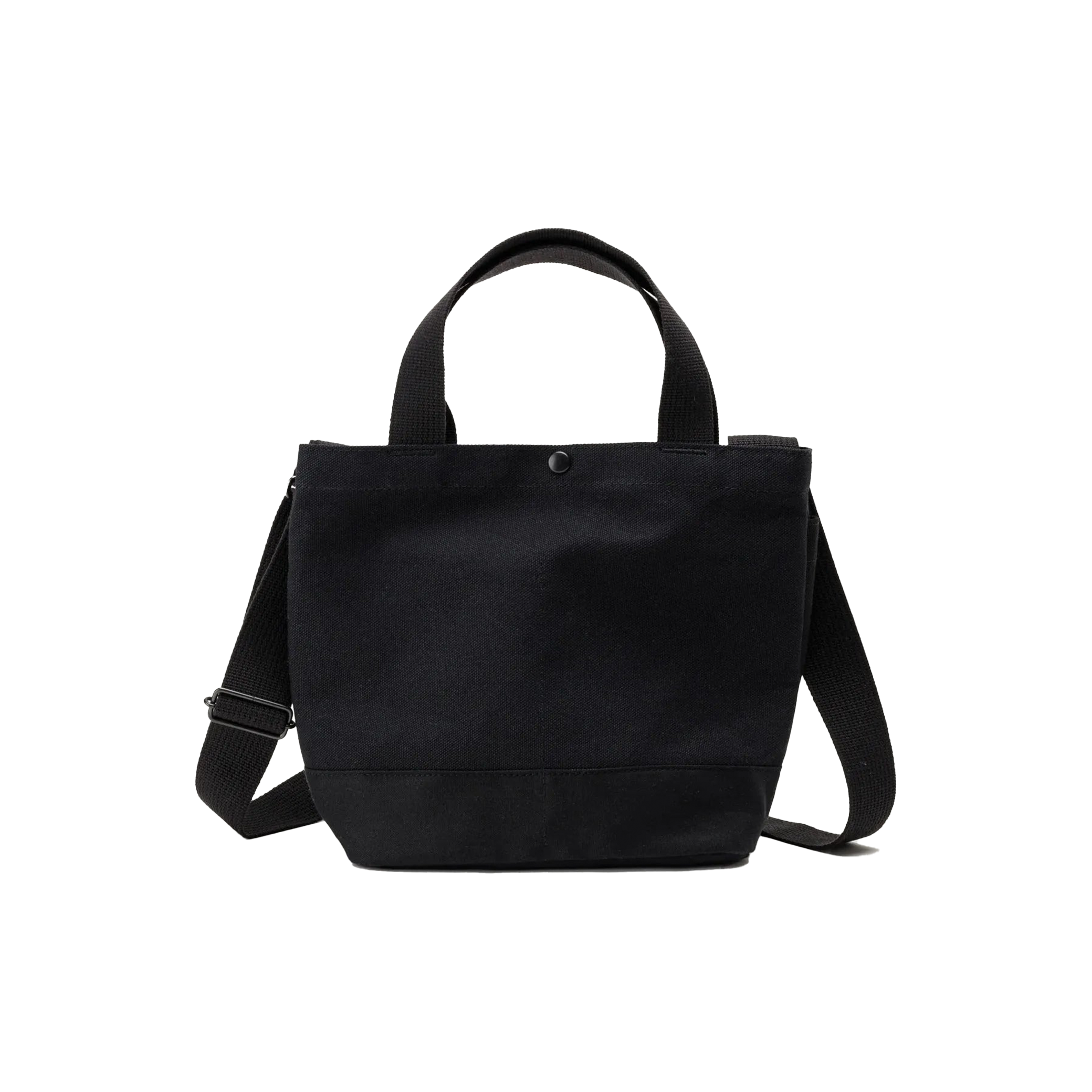 The New York Tote Small by Bags in Progress is a black cotton canvas bag made in Japan, featuring short handles, a detachable shoulder strap, and a button closure at the top.