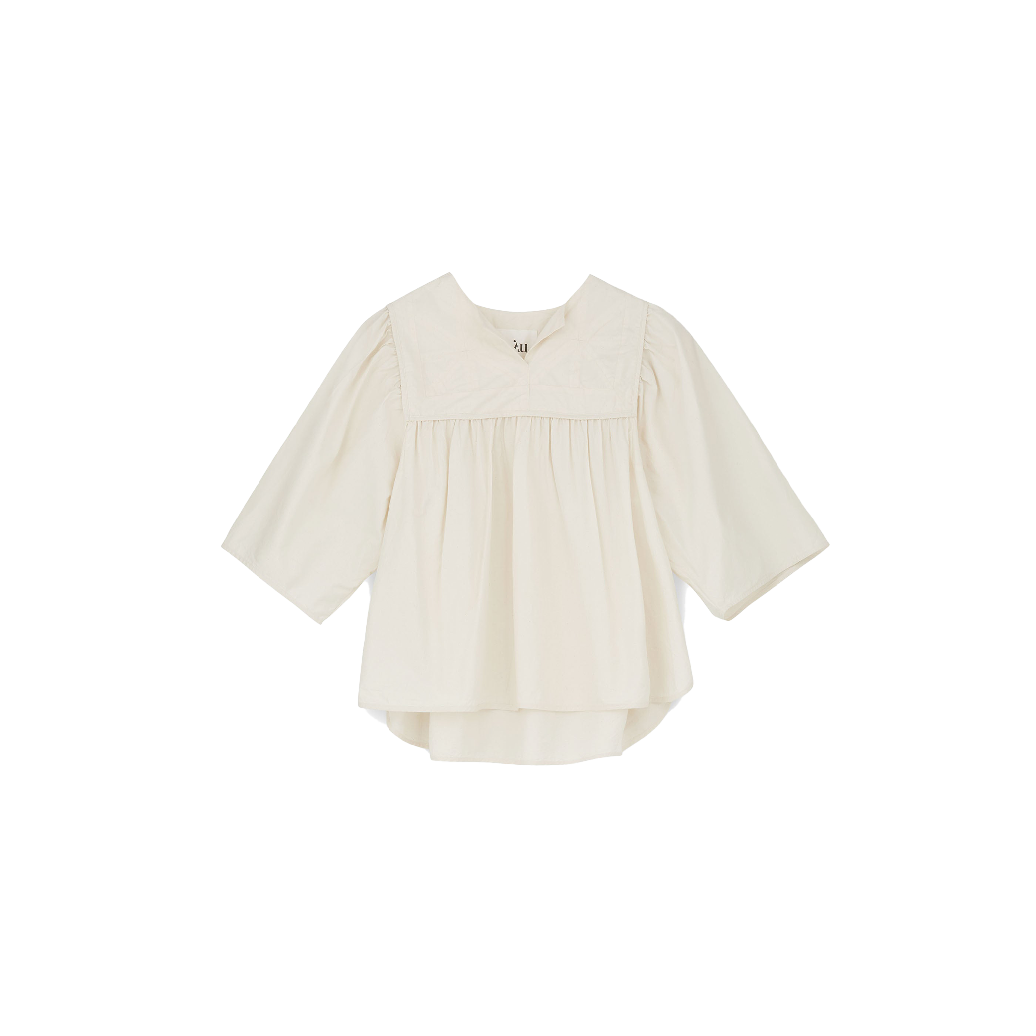 The Nomi Blouse by Aiayu features a cream color with long sleeves, a pleated front, and a wide collar, all crafted from sustainable materials. This 70s-inspired design is elegantly captured against a plain black background.