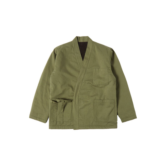 Reversible Kyoto Work Jacket in Light Olive Twill/Sherpa by Universal Works, with a v-neck and multiple front pockets, displayed on a white background.