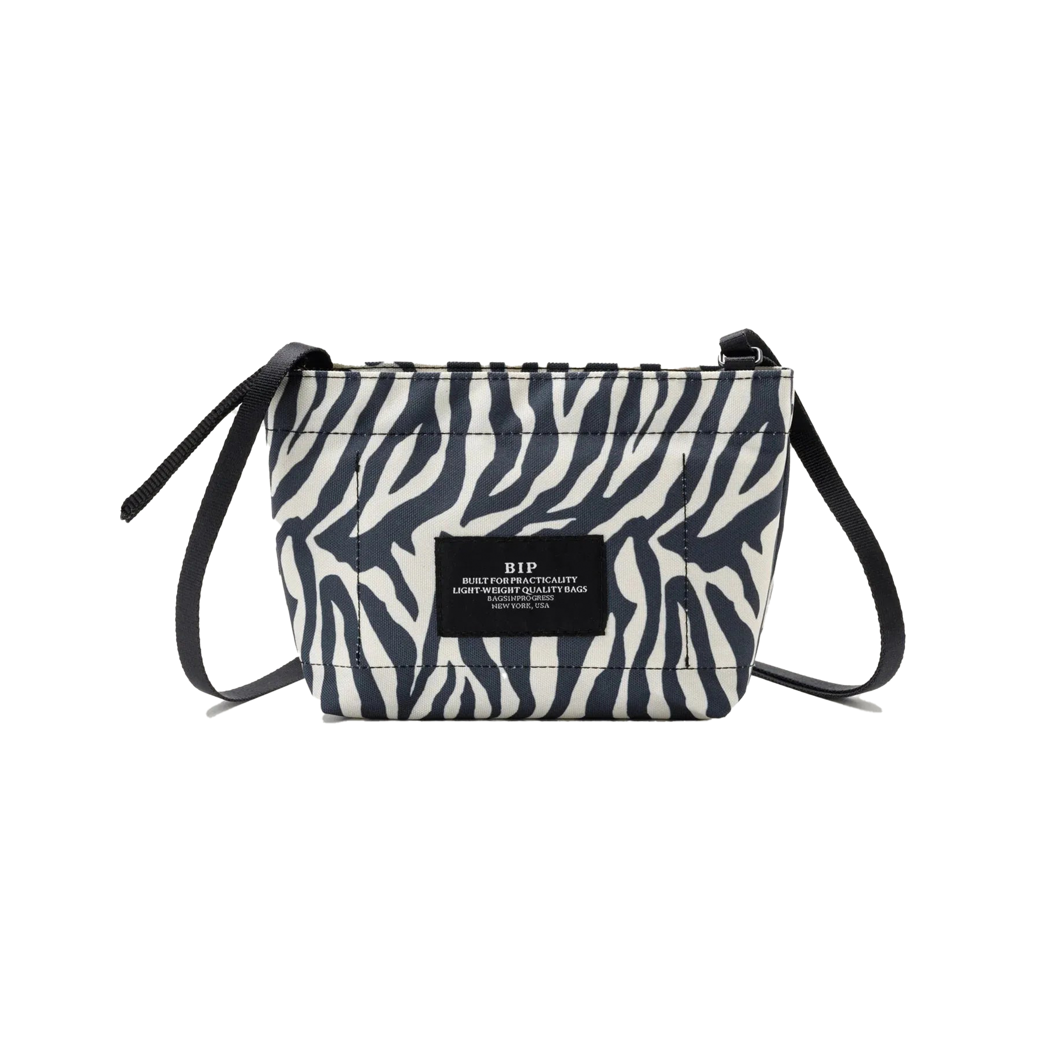 Introducing the Zipper Pouch Mini by Bags in Progress, a stylish shoulder bag featuring a zebra-print design crafted from recycled polyester. It is accented with black drawstrings and includes a label on the front.