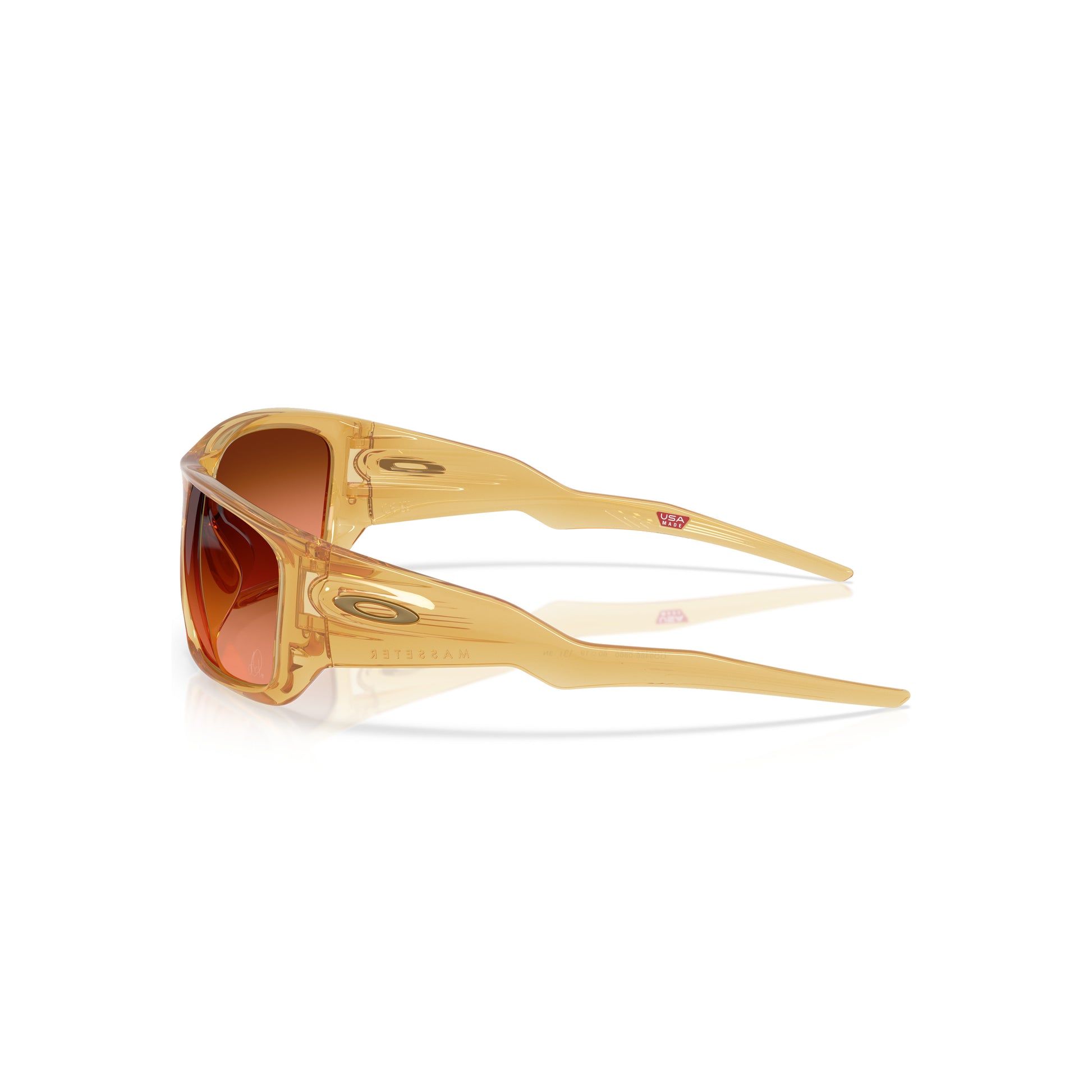 The Oakley Alexia Putellas Signature Series Masseter sunglasses feature a Trans Light Curry frame, orange-tinted Prizm Brown Gradient lenses, and wide angular arms, shown in profile against a white background.