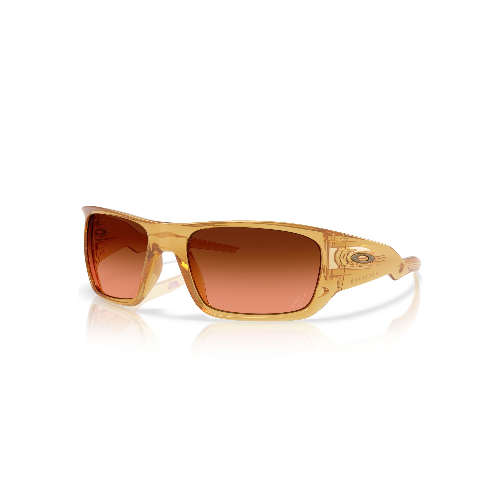 The Oakley Alexia Putellas Signature Series Masseter sunglasses, featuring rectangular Trans Light Curry frames and orange gradient lenses with Prizm Brown Gradient technology, are displayed on a white background with a subtle reflection.