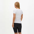 A person wears a Rohnisch Jacquard Short Sleeve Tee and black shorts, both made from recycled polyester, standing against a plain white background.