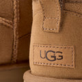 A close-up of the W Classic Ultra Mini Ugg boots shows the iconic logo stitched onto the suede exterior with an ultra-lightweight sole.