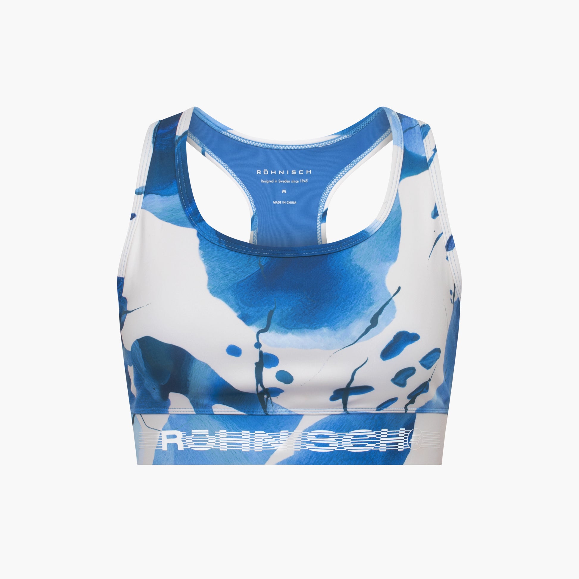 The Emblem Racerback Sportsbra by Rohnisch is a blue and white high support bra with abstract patterns, displaying the brand on the front band. Its moisture-wicking fabric keeps you comfortable and fresh during intense workouts.