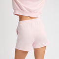 A person is wearing a Rohnisch Soft Sweatshort set in light pink, made from soft Terry fabric, shown from the back.