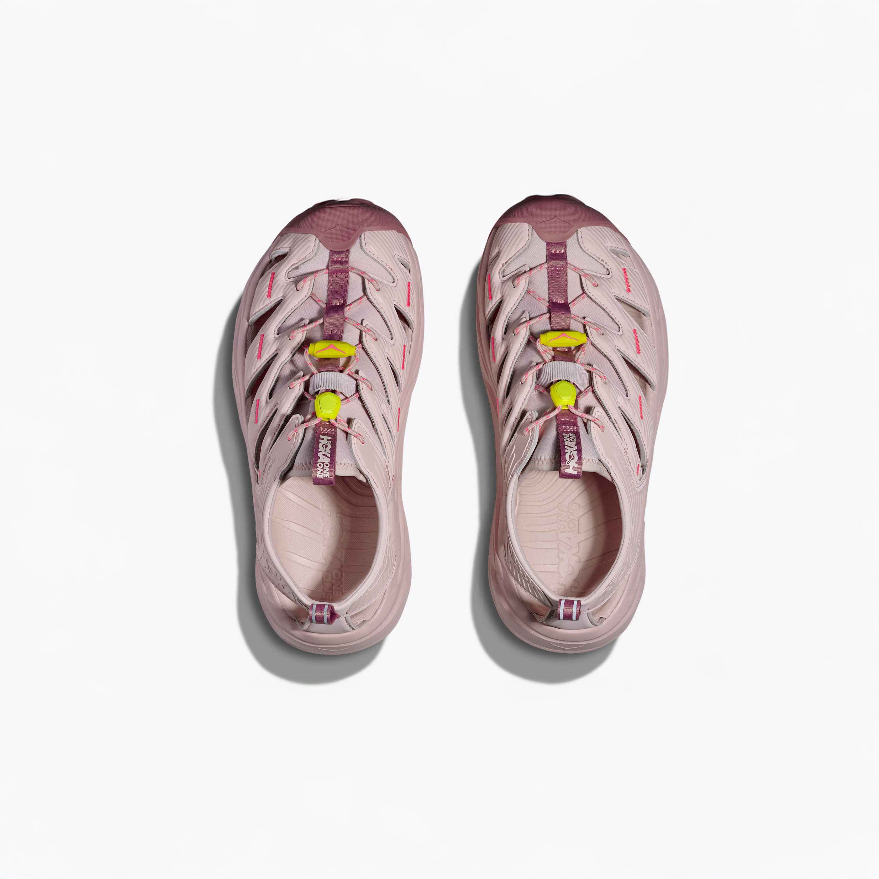 A pair of Hoka U Hopara shoes in Rose Tea/Neon Rose with purple and yellow accents and a Quick Lace system, shown from above on a white background.