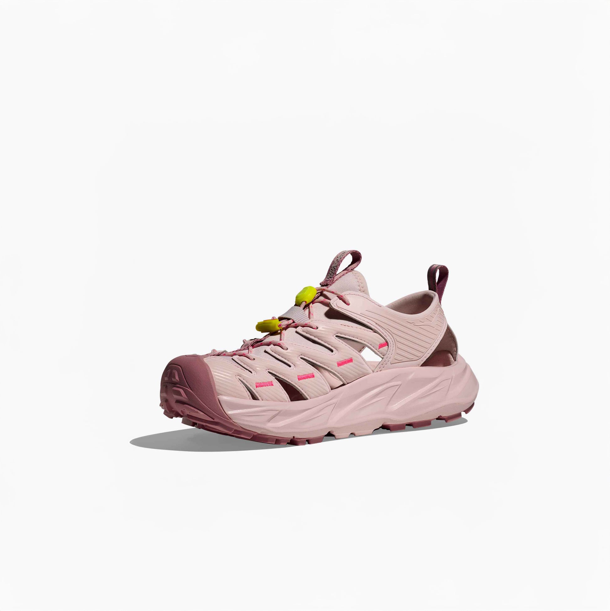 The Hoka U Hopara in Rose Tea/Neon Rose is a pink athletic hiking sandal with a chunky sole, closed toe, open sides, and a yellow Quick Lace toggle, shown on a white background.